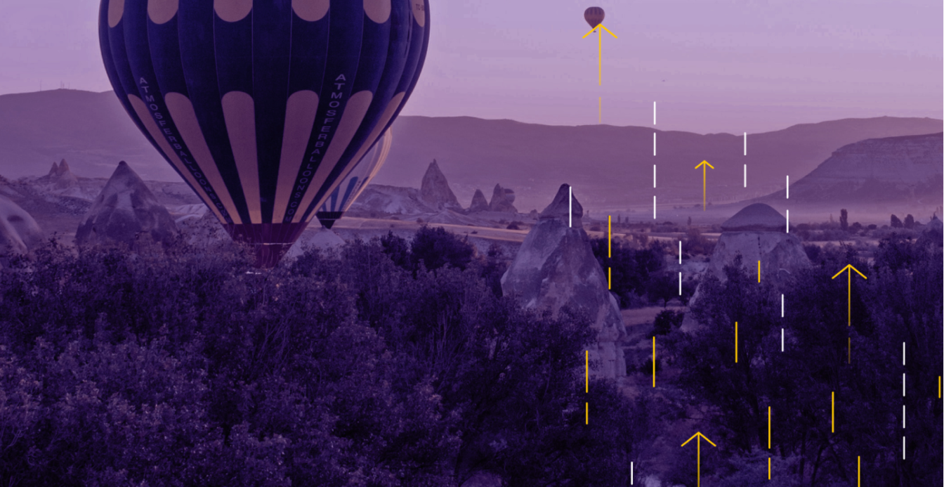 Hot air balloons floating over a rocky landscape with upward-pointing graphic arrows overlayed