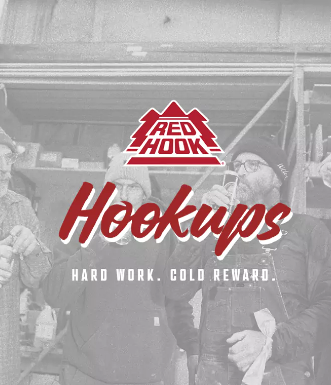 Black-and-white image of workers enjoying Redhook beer, with the "Hookups" logo and slogan "Hard Work. Cold Reward."