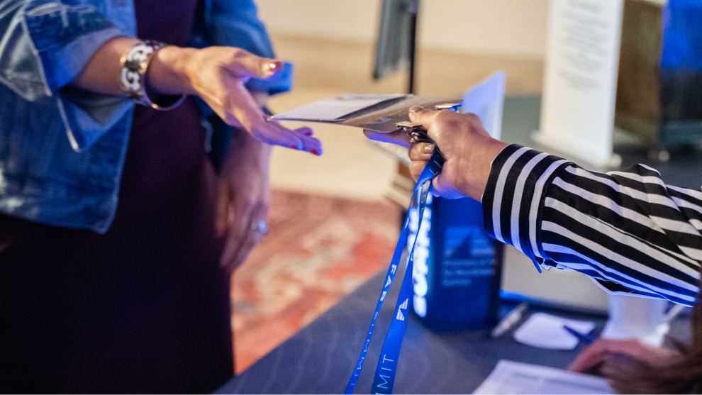 Event badge being handed to attendee