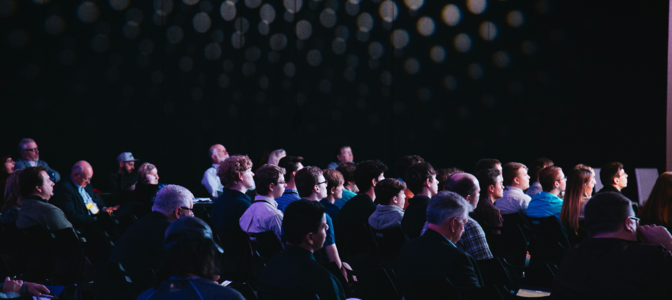 Group of professionals taking notes while at a skilling event.